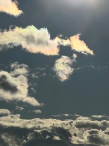 Sunset over the South Coast, UK. Clouds and sky are grey and white however the top clouds and tinged with yellow, pinks and blues